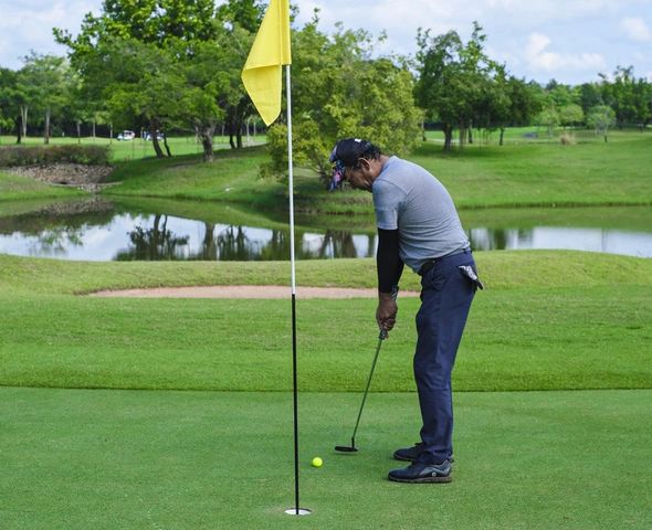 1 person golfing golf course grass and nature