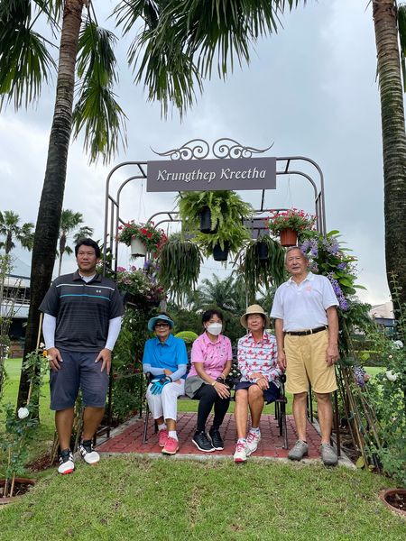 5 people people standing outdoors and palm trees