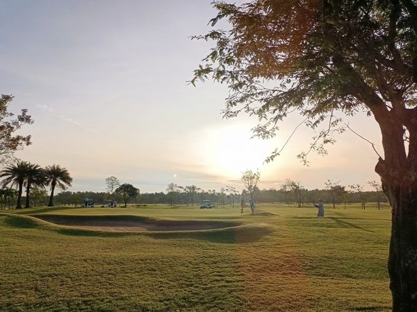 Bangpakong Riverside Country Club 2 people sky nature grass tree and golf course