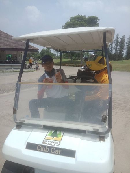The Pine Golf Club 2 people people golfing golf cart golf course and text