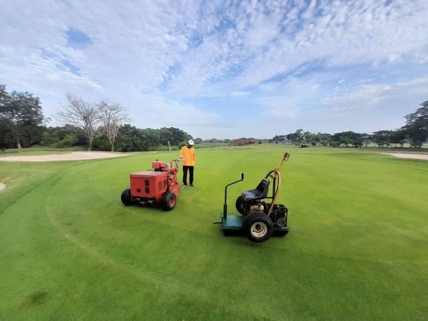 Bangpakong Riverside Country Club 1 person golfing golf cart golf course and grass