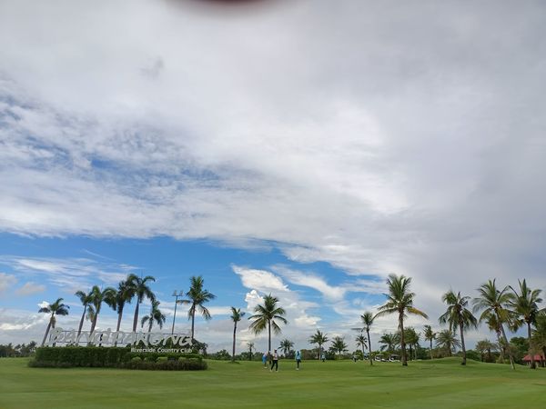 Bangpakong Riverside Country Club 2 people people golfing golf cart grass golf course and cloud