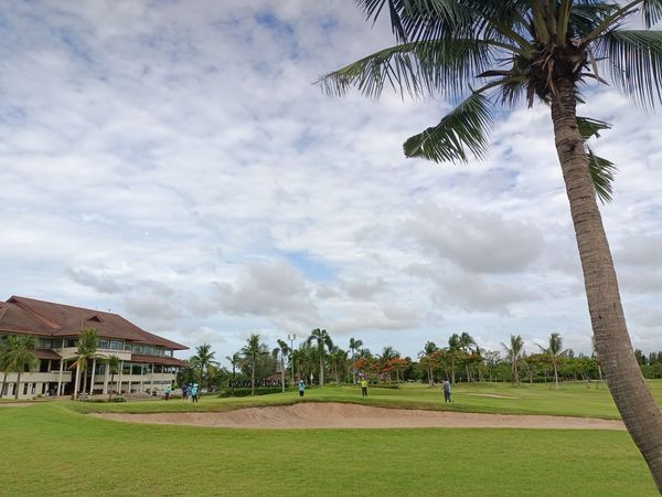 Bangpakong Riverside Country Club 2 people people golfing golf cart grass cloud and golf course