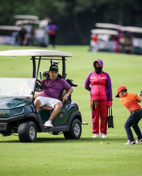 Lotus Valley Golf Resort 4 people people golfing golf cart golf course and text