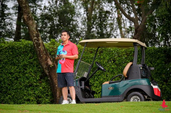 Lotus Valley Golf Resort 1 person golfing golf cart golf course and text