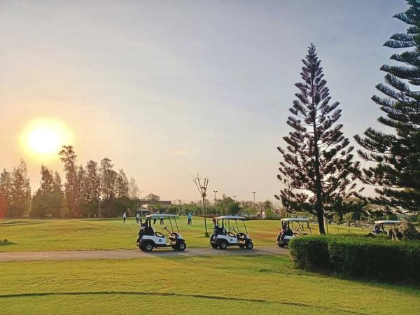 Bangpakong Riverside Country Club 2 people people golfing golf cart twilight and golf course