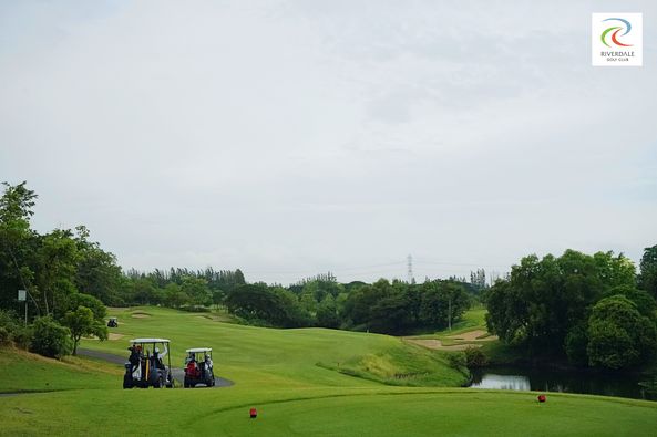 Riverdale Golf Club 1 person golfing golf cart golf course and text
