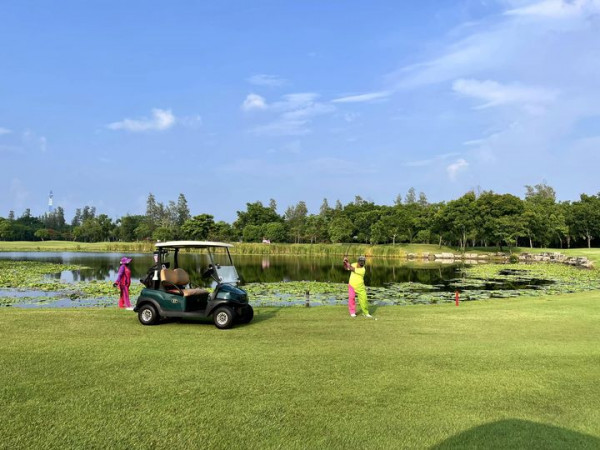 Lotus Valley Golf Resort 4 people people golfing golf cart water hyacinth golf course and grass
