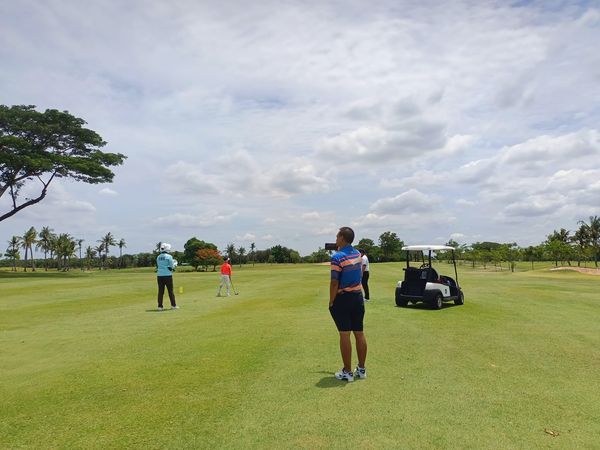 Bangpakong Riverside Country Club 3 people people golfing golf cart and golf course