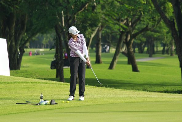 Lotus Valley Golf Resort 1 person golfing and golf course