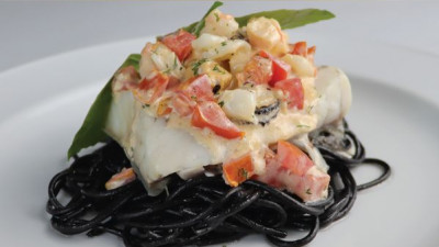 Poached Sea Bass with Tomato and Seafood Cream Sauce served with Black Spaghetti