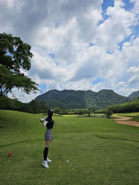 Bangpakong Riverside Country Club 1 person golfing grass cloud and golf course