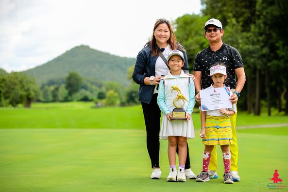 Alpinegolfresort Chiangmai 2 people child people golfing golf course and text
