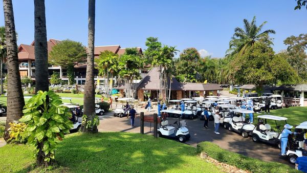 Summit Green Valley Chiangmai Country Club 4 people outdoors and palm trees