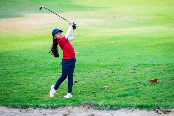 Alpinegolfresort Chiangmai 1 person playing a sport and grass