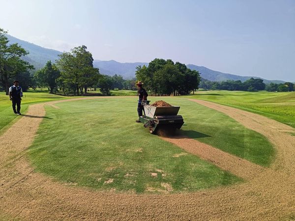 Alpinegolfresort Chiangmai 2 people people golfing golf cart golf course and grass