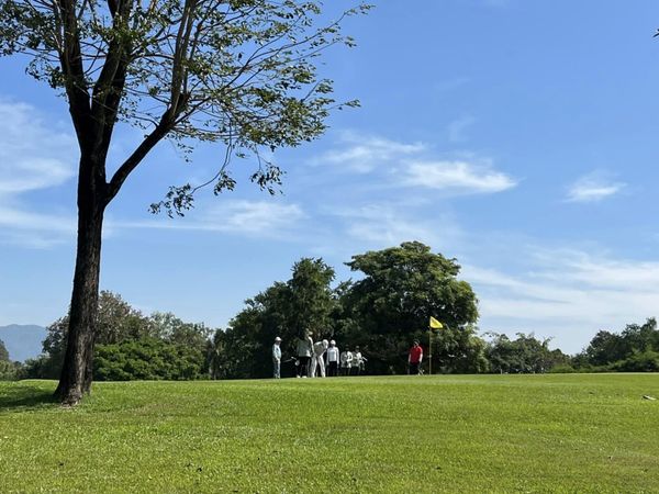 Bangpra Golf Club and Resort 3 people grass and tree Bangpra Golf Club and Resort 3 people grass and tree