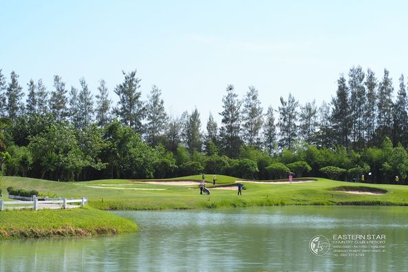 Eastern Star Country Club amp Resort 3 people people golfing golf course lake and grass