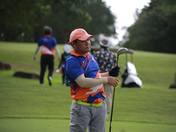 2 people people golfing and grass