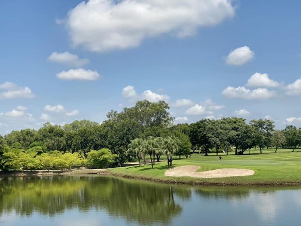 Muang Ake Golf Club 2 people golf course tree nature and grass