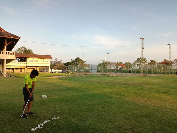 Bangpakong Riverside Country Club 1 person playing soccer playing football grass twilight and text