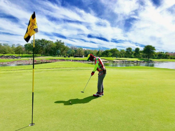 Lotus Valley Golf Resort 1 person golfing and golf course